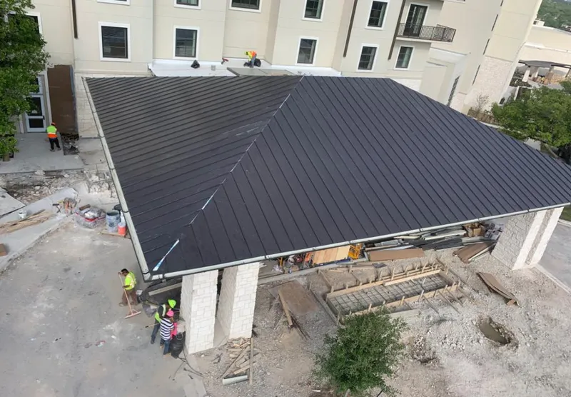 Metal roofing installation team working on a commercial building in Cobleskill